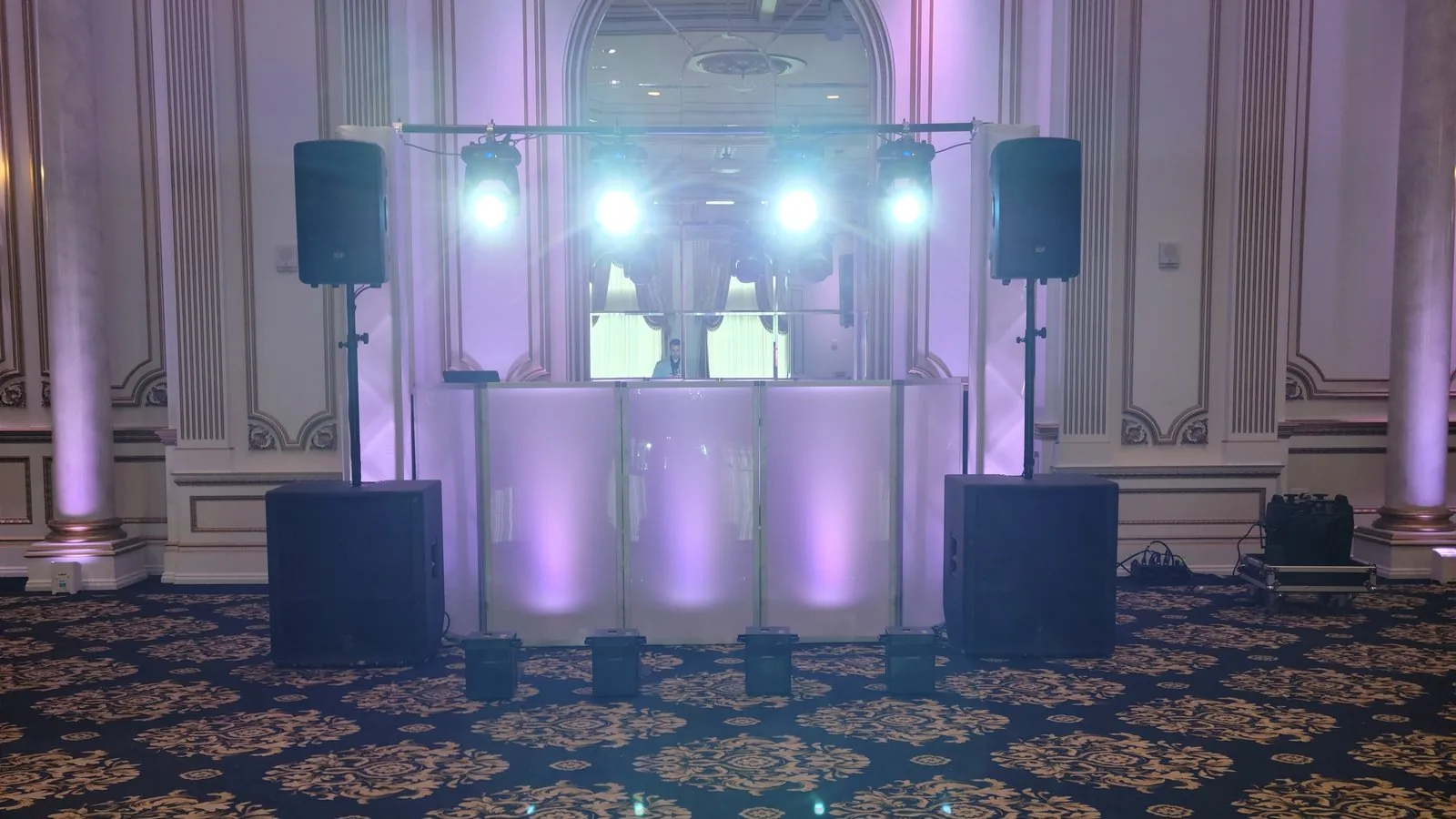 The Disaronno Events DJ setup at The Legacy Castle in Pompton Plains NJ — booth, speaker stacks and moving-head lighting against the ballroom's panelled walls and columns